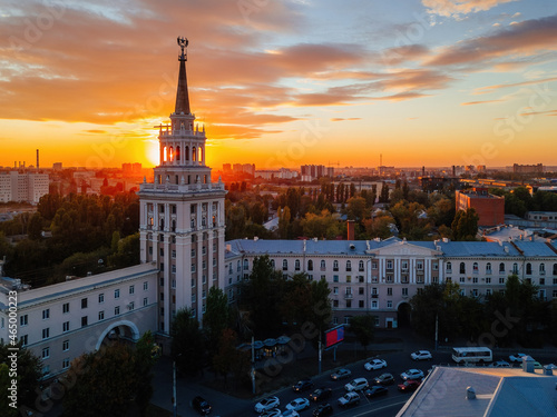 Evening summer Voronezh cityscape. Tower in architecture Stalinist empire at crimson sunset