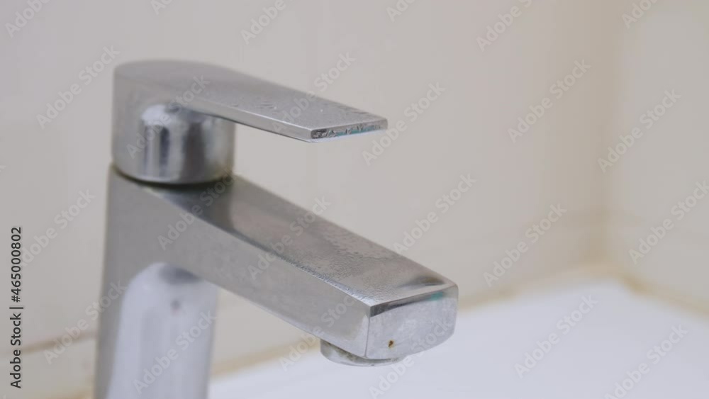Hand hands wearing white gloves use sanitizer clean tap before use at public toilet under the outbreak covid 19 Hand hands wearing white gloves use sanitizer clean tap before use at public toilet under the outbreak covid 19