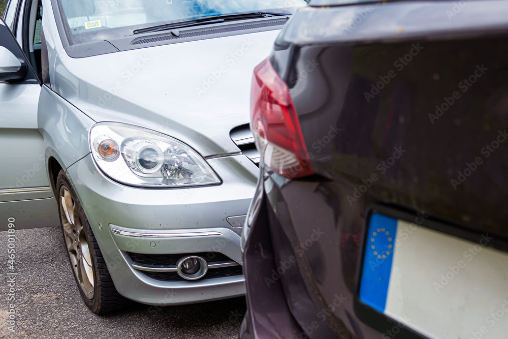close up of two cars damaged in road traffic accident