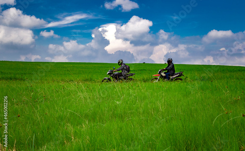 Young man on his motorcycle traveling through the countryside with copy space, man riding motorcycle in the countryside
