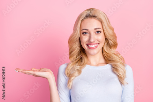 Photo of charming nice happy lady hold hand empty space object choose isolated on pink color background