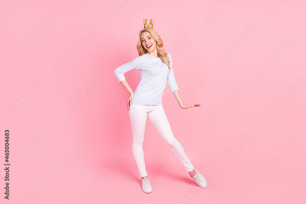 Full length photo of cheerful young happy woman queen wear golden tiara isolated on pink color background Full length photo of cheerful young happy woman queen wear golden tiara isolated on pink color background