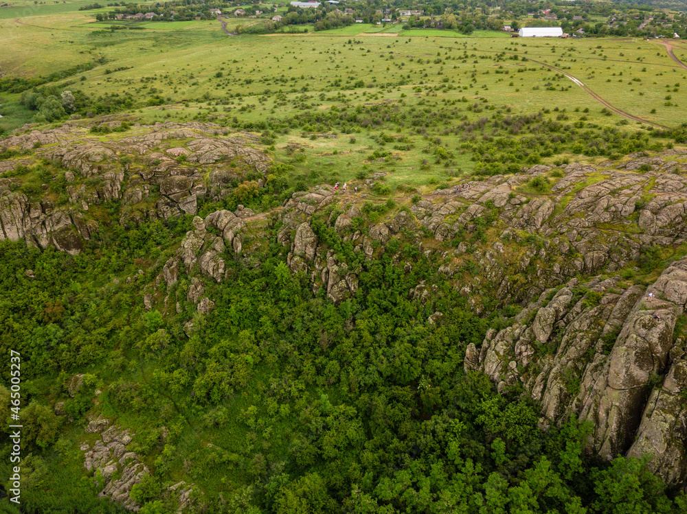 Obraz premium Top view from drone on green hills area