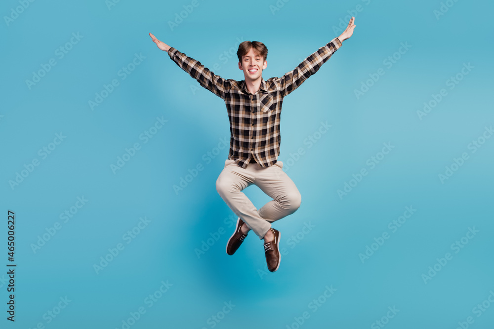 Full size photo of young cheerful guy have fun jump dream cool fly isolated on violet color background