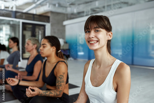 Happy millennial girl train practice yoga at group class