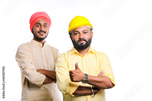 Young indian engineer with farmer on white background. photo