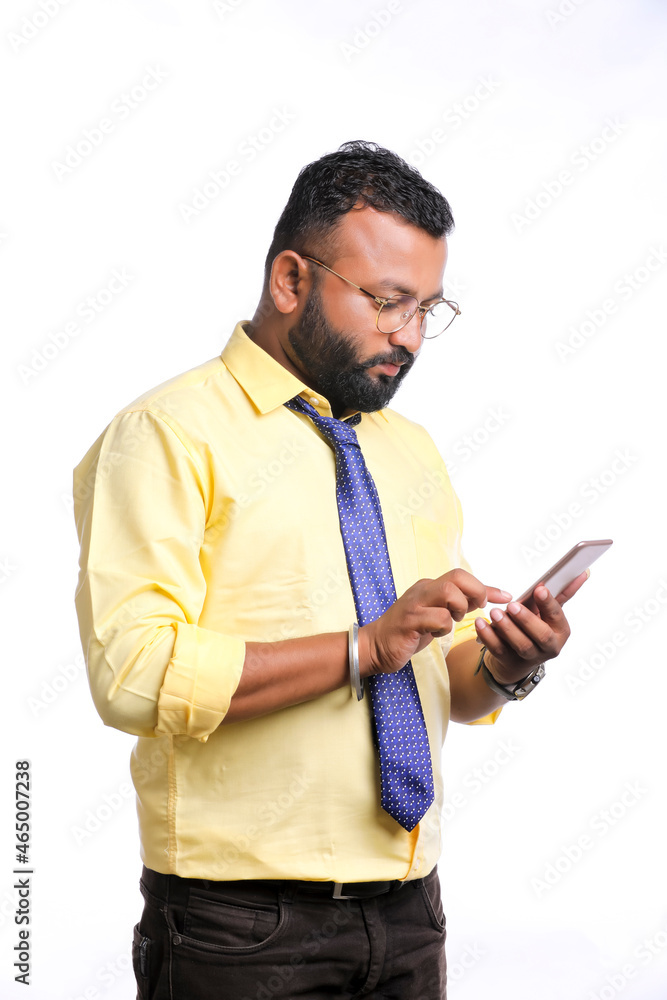 Young indian officer or student using smartphone on white background. Young indian officer or student using smartphone on white background.