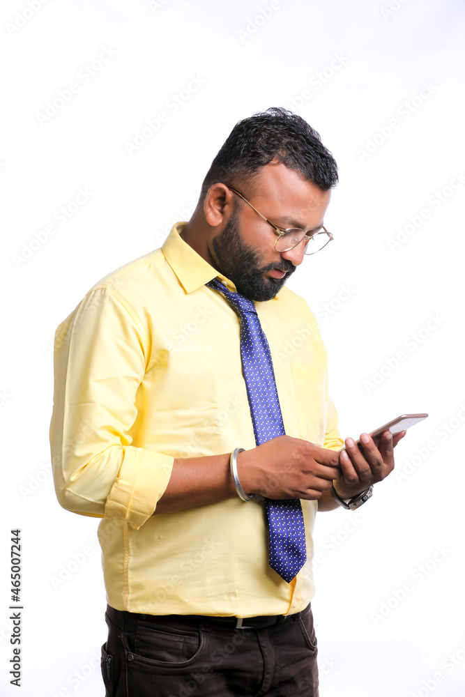 Young indian officer or student using smartphone on white background. Young indian officer or student using smartphone on white background.