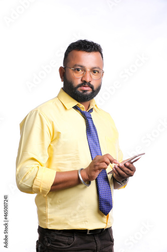 Young indian officer or student using smartphone on white background.
