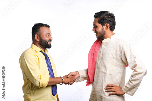 Young indian officer shake hand with farmer on white background.