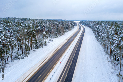 Aerial bird-eye view on freeway road in the winter field