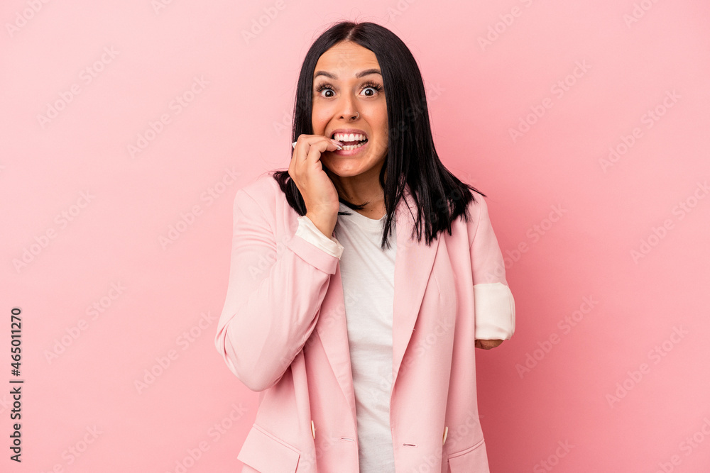 Young caucasian woman with one arm isolated on pink background biting fingernails, nervous and very anxious. Young caucasian woman with one arm isolated on pink background biting fingernails, nervous and very anxious.