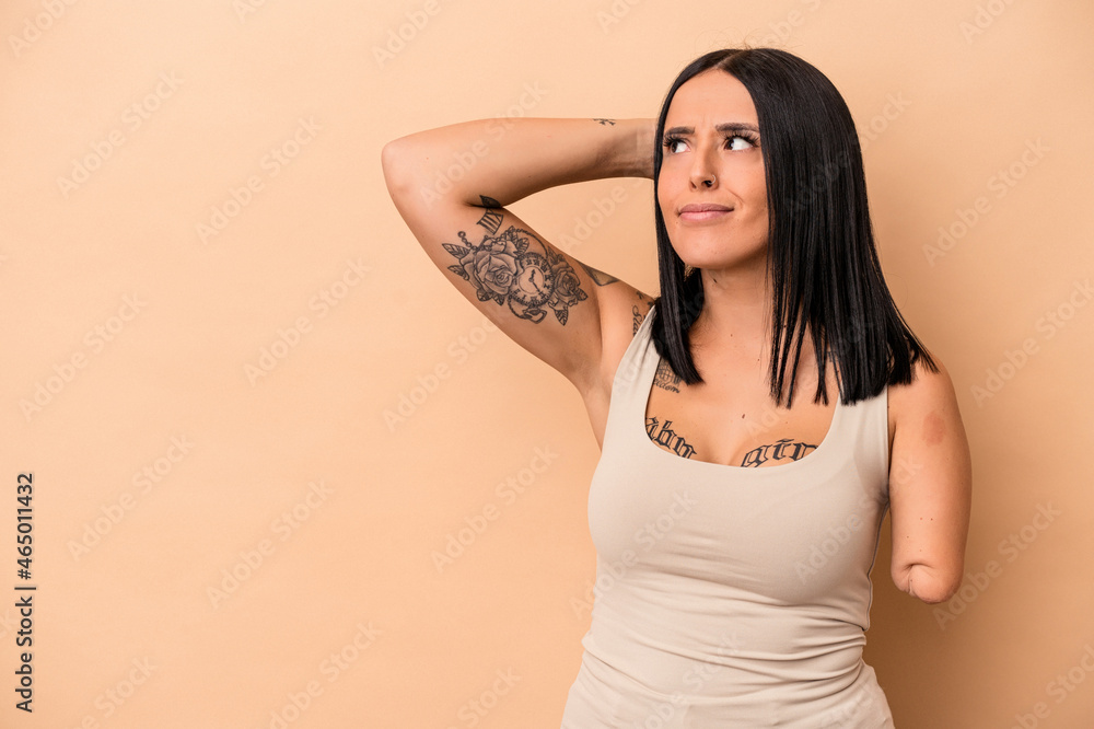 Young caucasian woman with one arm isolated on beige background touching back of head, thinking and making a choice. Young caucasian woman with one arm isolated on beige background touching back of head, thinking and making a choice.
