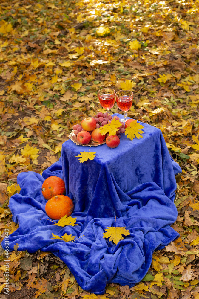 Autumn concept with fruit and drink on yellow leaves background