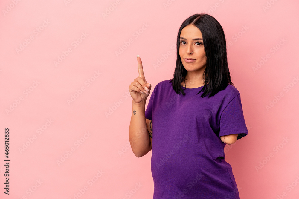 Young pregnant woman with one arm isolated on pink background showing number one with finger. Young pregnant woman with one arm isolated on pink background showing number one with finger.