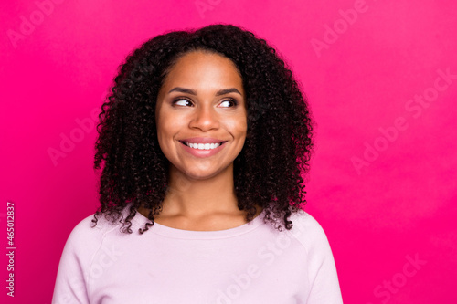 Photo of funny millennial brunette lady look empty space wear pink sweater isolated on magenta color background