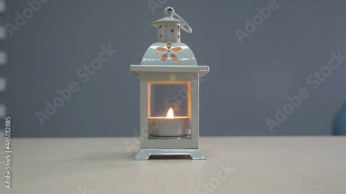 blowing out a burning candle in a candlestick