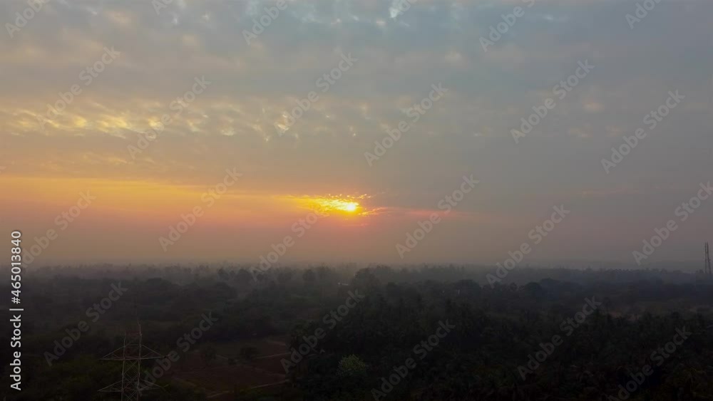 Aerial view over a misty forest in sunset light. Marvelous view, flying over the forest in the evening Aerial view over a misty forest in sunset light. Marvelous view, flying over the forest in the evening