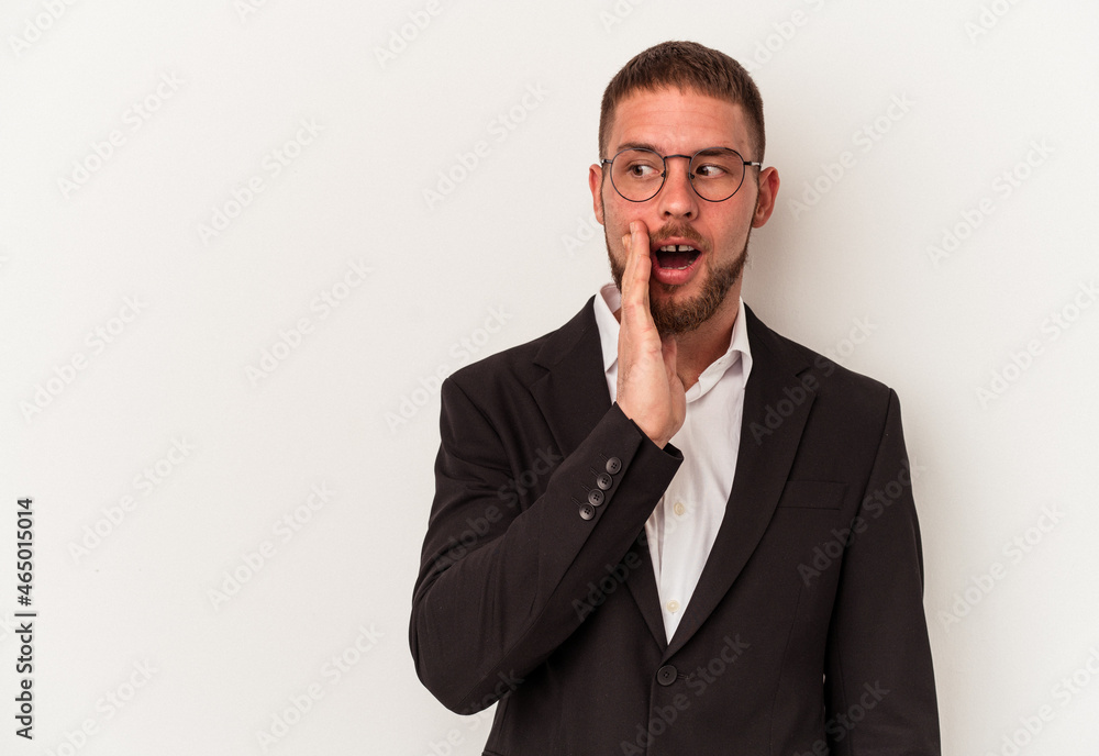Young business caucasian man isolated on white background is saying a secret hot braking news and looking aside Young business caucasian man isolated on white background is saying a secret hot braking news and looking aside