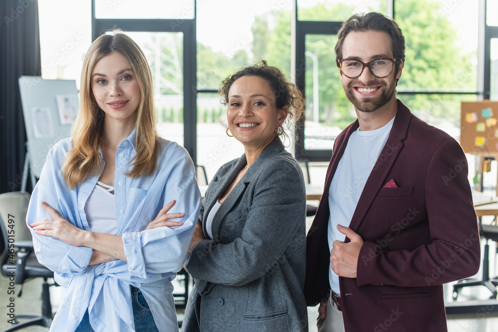 Fototapeta premium Multiethnic business people smiling at camera in office