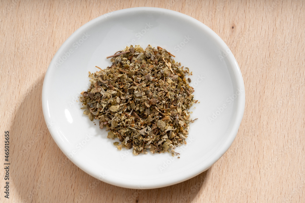 Detailed and large close up shot of marjoram on a small plate Detailed and large close up shot of marjoram on a small plate