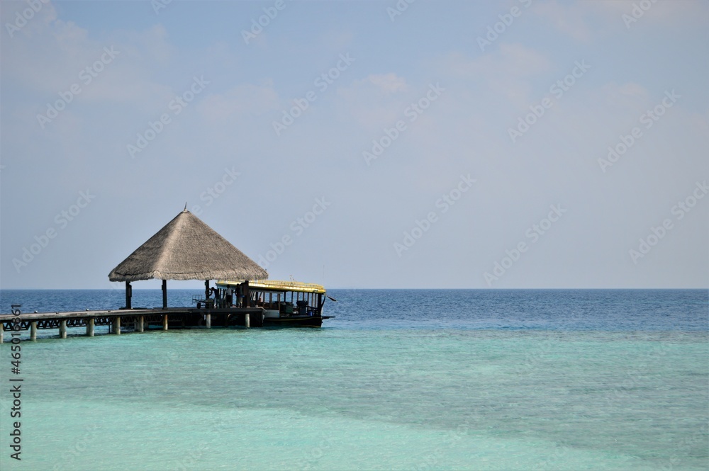 RANGALI ISLAND, MALDIVES - JANUARY 06, 2018: Beautiful tropical Maldives pier and island with beach and sea on sky for holiday vacation background, boat and ship departure, arrival
