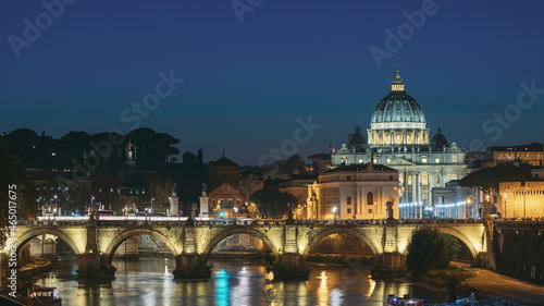 Vatican, Italy. Papal Basilica Of St. Peter In The Vatican And Aelian Bridge In Evening Night Illuminations. Day To NIght Time Lapse. Sunset Time