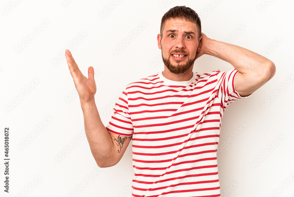 Young caucasian man with diastema isolated on white background screaming with rage. Young caucasian man with diastema isolated on white background screaming with rage.