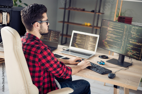Canvas Print Profile side view portrait of attractive focused skilled guy technician sitting