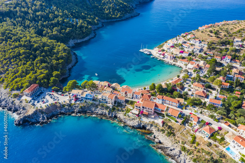 Assos picturesque fishing village from above, Kefalonia, Greece. Aerial drone view. Sailing boats moored in turquoise bay © Igor Tichonow