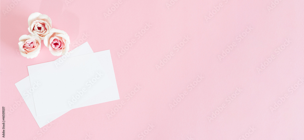Blank white greeting card with pink rose flowers. Mock up.
