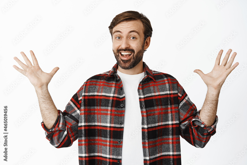 Excited bearded man smiling, showing big thing, large product in hands, standing over white background Excited bearded man smiling, showing big thing, large product in hands, standing over white background