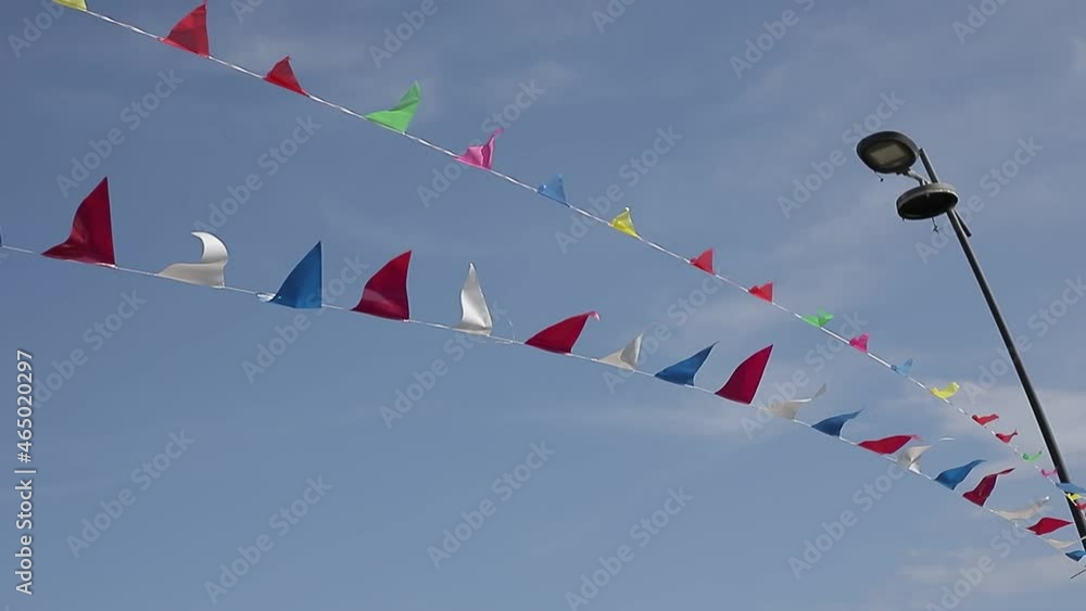 Triangle Racing Flags String Screenshot against a clear blue sky background of colorful triangle ...