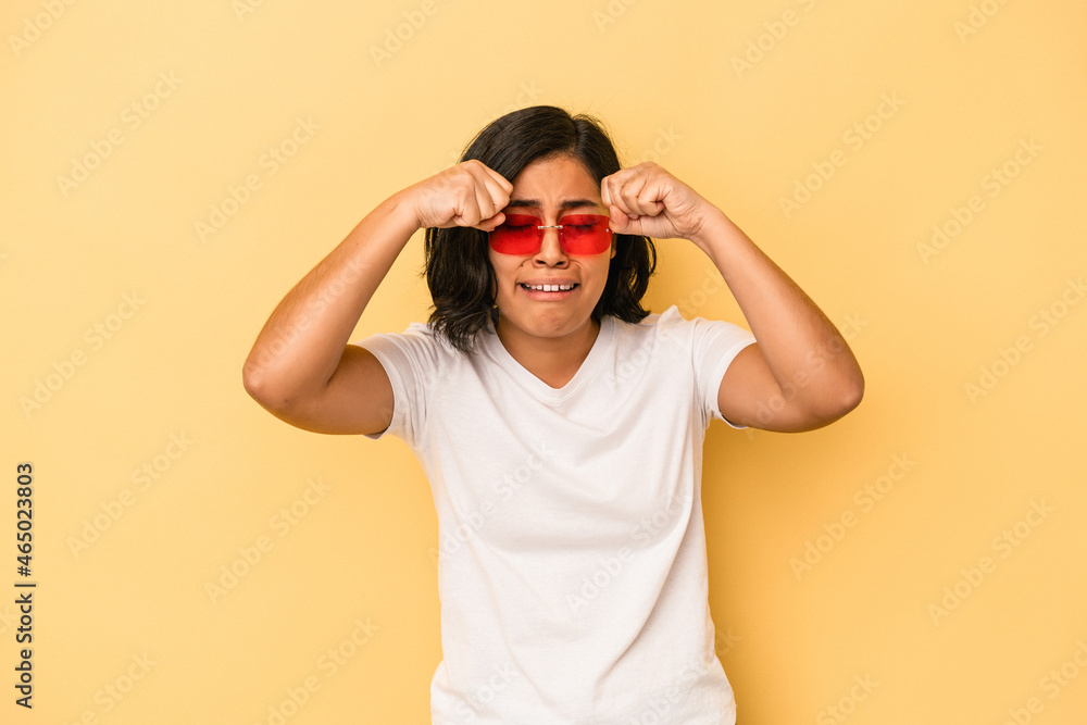 Young latin woman isolated on yellow background whining and crying disconsolately. Young latin woman isolated on yellow background whining and crying disconsolately.