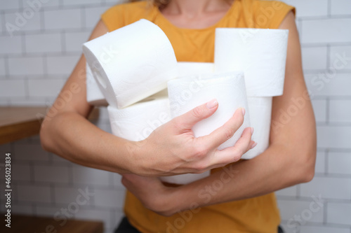Woman holding rolls of toilet paper, close-up