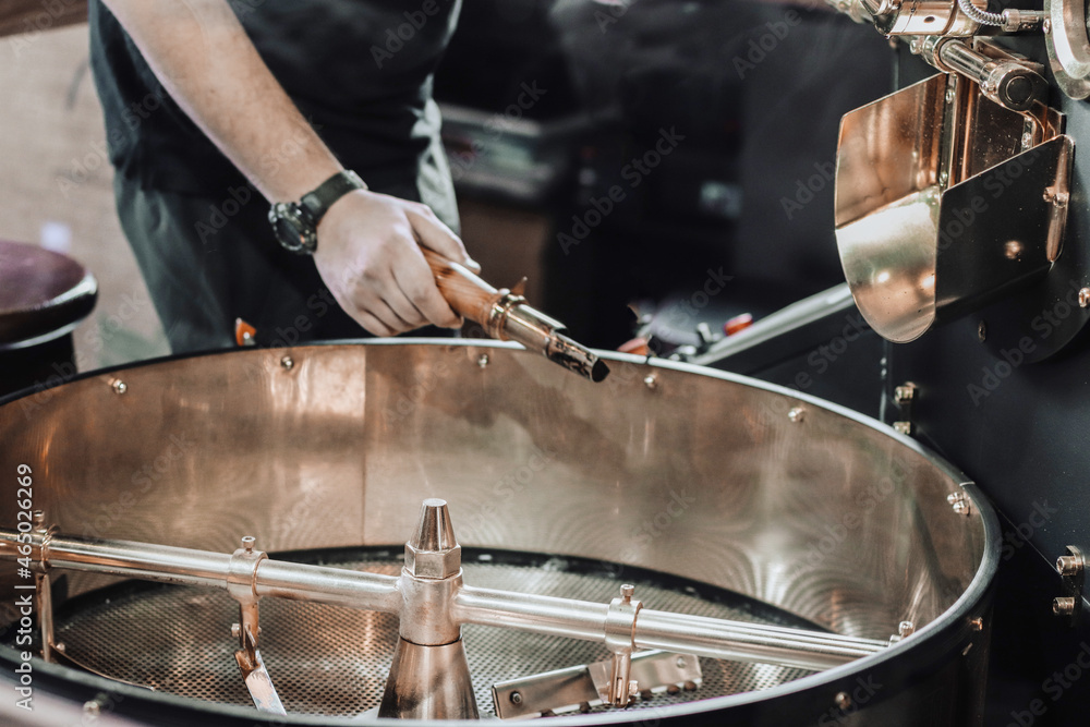 Fototapeta premium Fresh roasted coffee. Roasting process of coffee beans at factory