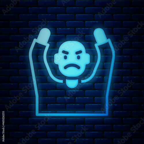 Glowing neon Thief surrendering hands up icon isolated on brick wall background. Man surrendering with both hands raised in air. Vector