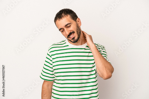 Young caucasian man isolated on white background having a neck pain due to stress, massaging and touching it with hand.