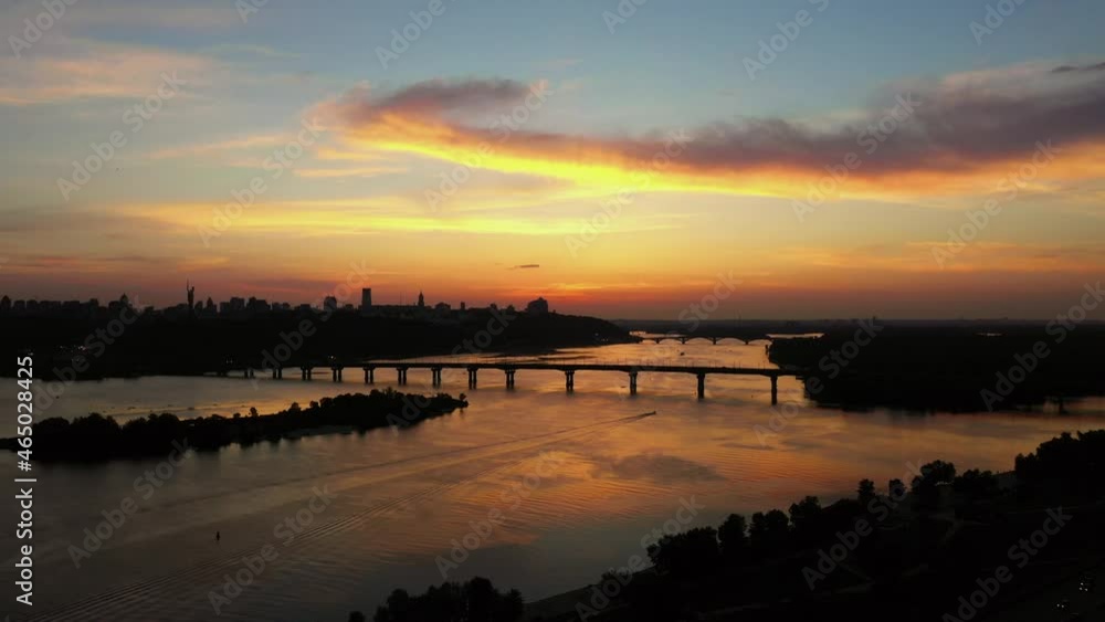 Big city scape with huge river and evening sunset sky. Big city scape with huge river and evening sunset sky.