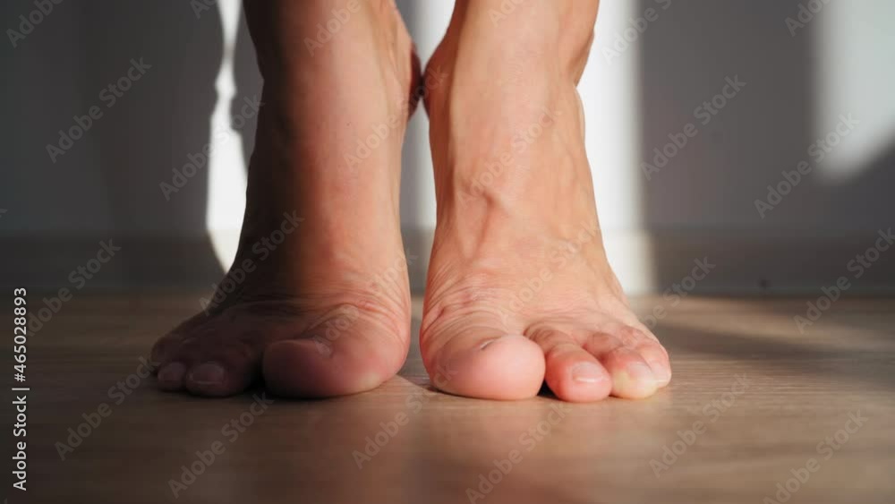 Close up, Beautiful Barefoot Female Feet in Bright Sunlight. Woman Stretches Her Legs. Body Care Concept. Warm Up the Ankles. Close up, Beautiful Barefoot Female Feet in Bright Sunlight. Woman Stretches Her Legs. Body Care Concept. Warm Up the Ankles.