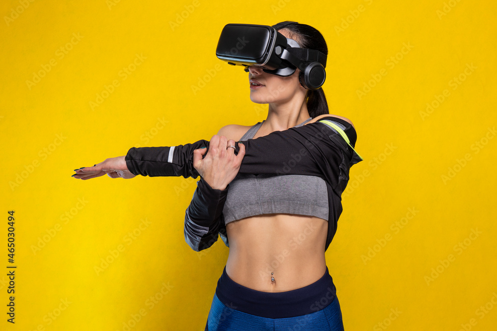 Beautiful sportive caucasian athlete sports woman training - Studio shooting with pretty slim brunette posing during gymnastics workout routine doing stretching wearing hi tech futuristic vr glasses Beautiful sportive caucasian athlete sports woman training - Studio shooting with pretty slim brunette posing during gymnastics workout routine doing stretching wearing hi tech futuristic vr glasses