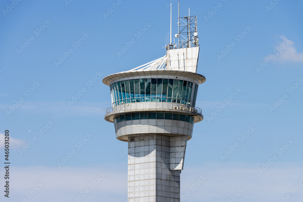 Airport air traffic control tower. Flights management center. Isolated blue sky background Airport air traffic control tower. Flights management center. Isolated blue sky background