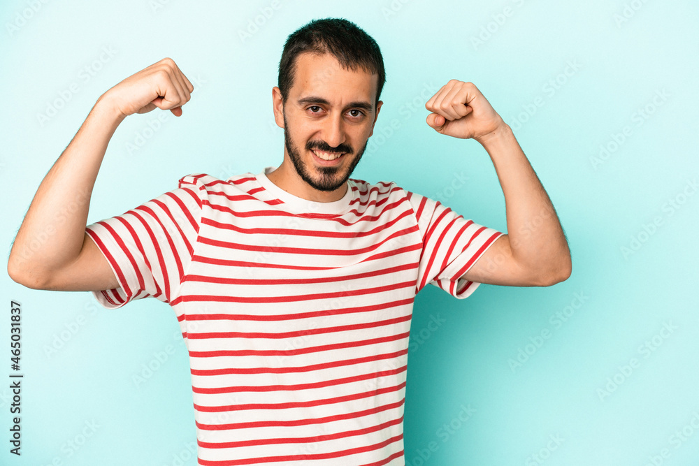 Young caucasian man isolated on blue background cheering carefree and excited. Victory concept. Young caucasian man isolated on blue background cheering carefree and excited. Victory concept.