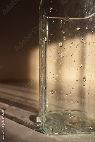 wet vase close-up. glass vase with water drops on it. wet jug close up. drops of water on a vase
