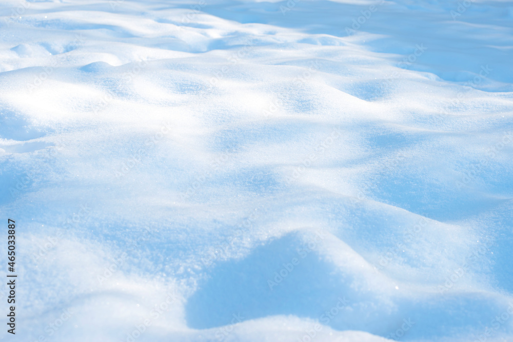 Sunny winter white snow background with blue shades of drifts