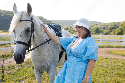 The woman with curly hair huddles to her horse