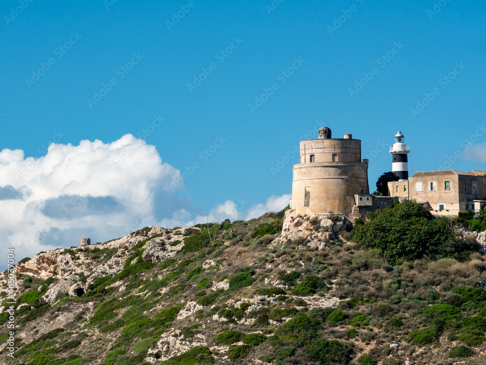 White lighthouse tower nearby evergreen tree along the mountain White lighthouse tower nearby evergreen tree along the mountain