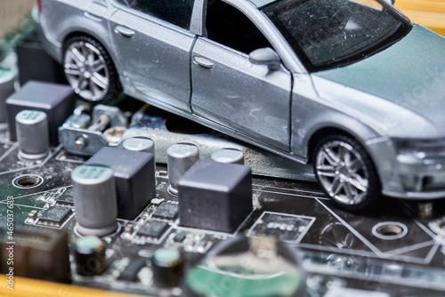 CPU chip and semiconductors with car toy. Global car chip shortage. Micro-chip shortage creates dearth of new cars. Computer chip shortage stalls car industry production