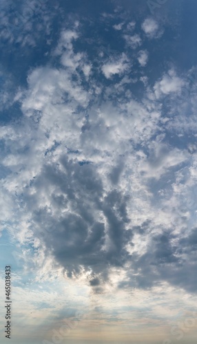 Fototapeta Naklejka Na Ścianę i Meble -  Fantastic clouds at sunrise, vertical panorama