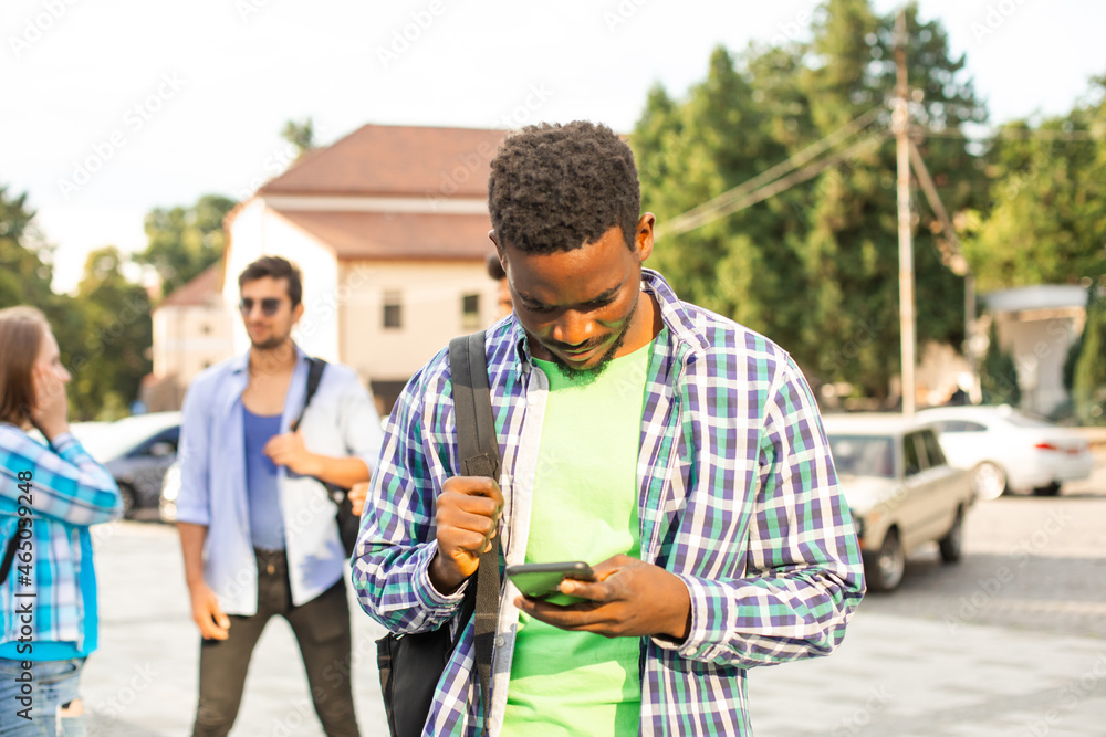 Fototapeta premium The young african student uses navigation on a smartphone